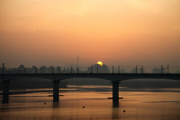 The morning sun rising above the Han River Bridge in Seoul