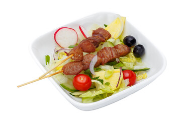 fried pieces of meat on sticks and vegetables. Isolated on a white background.