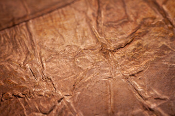 Extreme closeup of crumpled brass foil texture
