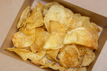 Crisps potato chips, salt and vinegar flavour, in a card carton box. Environmentally friendly biodegradable food packaging.