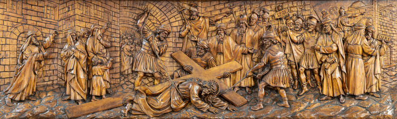 MILAN, ITALY - MARCH 5, 2024: The carved relief  Fall of Jesus under the cross  in the church Chiesa di San Camillo by Annibale Pagnoni (1900).