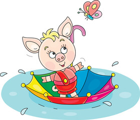Funny little pink piglet floating in its colorful toy umbrella through a large puddle after warm summer rain, vector cartoon illustration on a white background