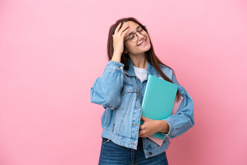 Young Ukrainian student woman isolated on pink background smiling a lot