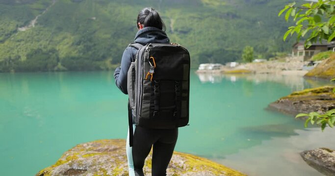 Hiking woman walk with a hiking backpack in Beautiful nature of Norway.