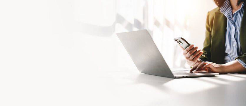 Typing on a smartphone Working online on laptop, computer and smartphone on white table at office. Facebook chat. Web meeting. Blogger. Journalist writing an article. online job idea