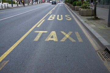 dedicated lane for buses and taxis, signs on the asphalt. information texts on the road.