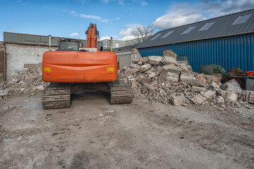 back of an orange demolition machine on steel tracks
