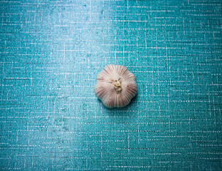 A garlic shot on a blue dining table. Garlic is a favorite condiment for Chinese.