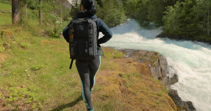 Hiking woman walk with a hiking backpack in Beautiful nature of Norway.