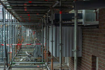 view of steel scaffolding pipes next to an apartment building