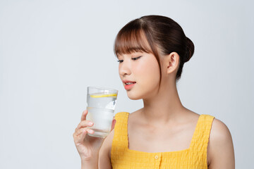 happy smiling young asian woman hold glass of water with lemon