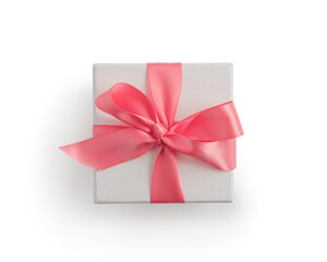 Top view of white paper present box with pink ribbon isolated on white background