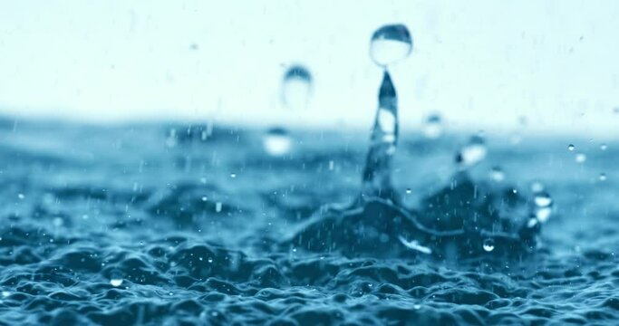 Rain water drops falling in super slow motion.