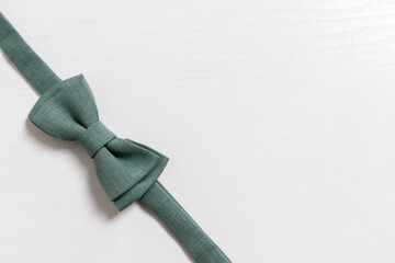Green bow tie for a child on a light background, Newborn. Birthday, father's day