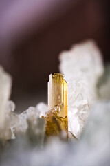 Small epidote crystals with white feldspar var adularia and brown axinite-(Fe).  Saint-Christophe-en-Oisans, Grenoble, France. Macro photography detail. 

