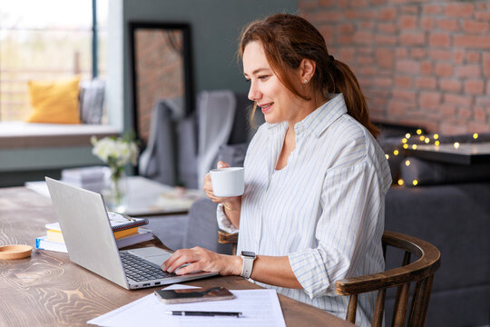 Young freelance businesswoman working from home. Businesswoman using laptop in home office