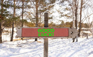 Good luck symbol. Concept words Good luck on beautiful wooden road sign. Beautiful forest snow blue sky background. Business, motivational good luck concept. Copy space. - Powered by Adobe