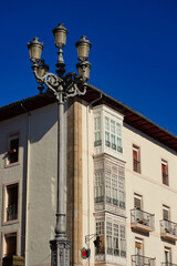 
Vitoria-Gasteiz, Euskadi. Spain. Street lamp in the foreground. Behind a house with white balconies typical of the city