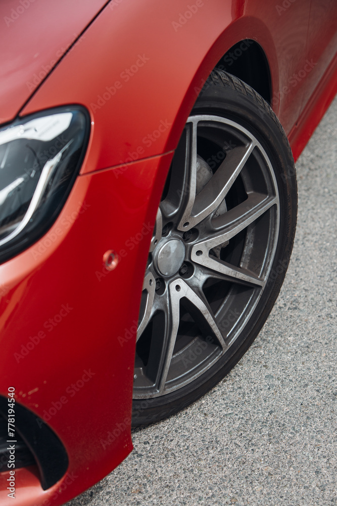 Poster Front wheel of modern car with a rims and tyre