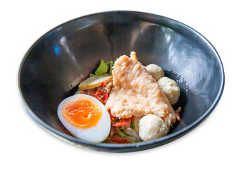 Top view of Dry Tom Yum Noodles with Boiled Egg, focus selective