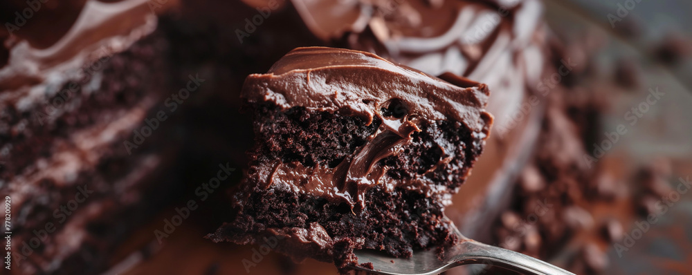 Wall mural decadent moist chocolate cake with rich frosting close-up