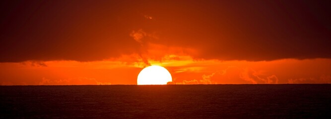 Radiant Sunset Glow: Mesmerizing 4K Ultra HD View of the Sun Setting Over the Horizon