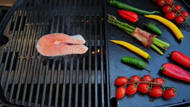 Put the salmon steak on the grill. Grilled vegetables with steak fish