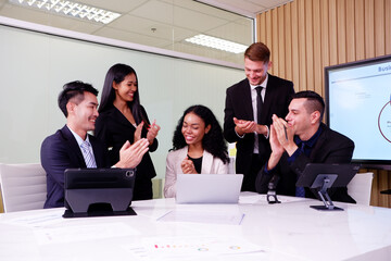 Businessmen and employees smile happily at business success.