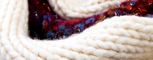 Knitted woolen sweaters. A bunch of knitted winter, autumn clothes, sweaters, knitwear, space for the text.