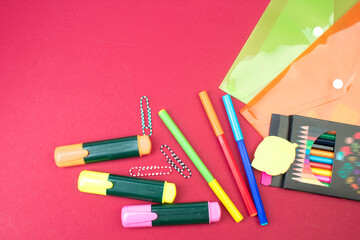 Back to school. Stationery on a Burgundy table. Office desk with copy space. Flat lay.