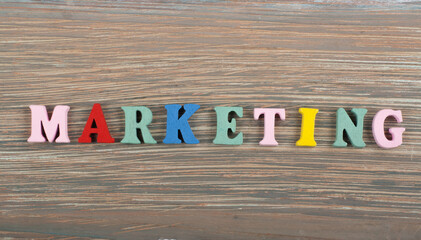 MARKETING word on wooden background composed from colorful abc alphabet block wooden letters, copy...