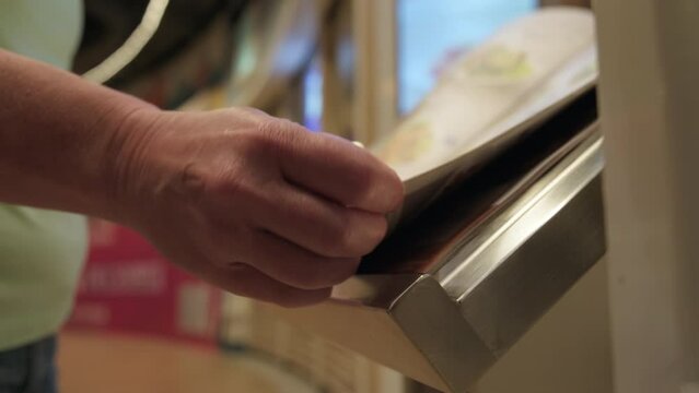Man scrolling through menu of restaurant or cafe.