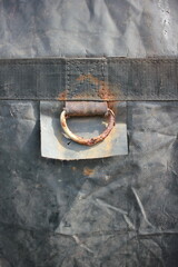 An old rusty loop hanging on a piece of cloth.