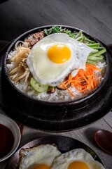 Sizzling Bi Bim Bap: 4K Ultra HD Top View, Mixed Vegetables, Rice, and Hot Sauce in Cast Iron Pot