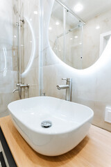 Bathroom with sink, mirror, and shower fixtures for property