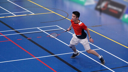 young man plays single badminton