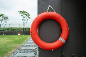 A lifebuoy hangs on the wall of the apartment's shared swimming pool.