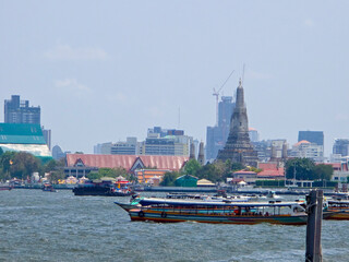 Passenger boats travel on the Chao Phraya River in the Phra Nakhon District in Bangkok, Thailand during the day