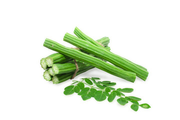 Moringa Oleifera or drumstick vegetable with leaves isolated over white background © Kiran