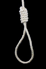 hangman's noose made of natural rope hanging on a black background