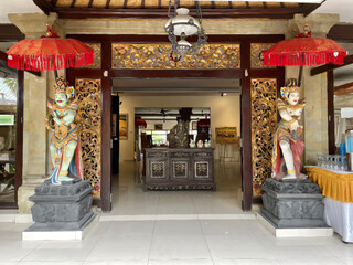 Restaurant entrance with Balinese statues - obrazy, fototapety, plakaty