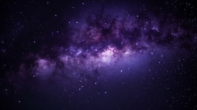A dark sky with a purple galaxy and many stars. The stars are scattered throughout the sky and the galaxy is very large
