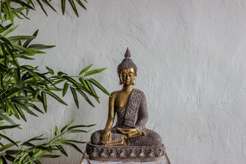 Estatua de Buda dorada en fondo blanco.
La estatua está ubicada contra un fondo blanco texturizado y está rodeada de hojas de bambú. La composición transmite una sensación de paz y espiritualidad. - obrazy, fototapety, plakaty