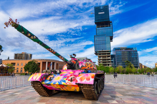 An artistic representation of a tank from the second world  war with vibrant colors  displayed at Tirana's Skanderbeg Square. 
