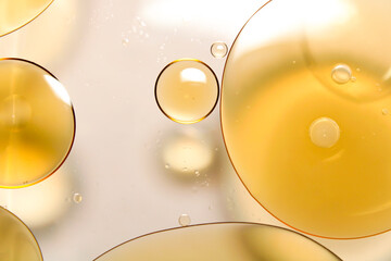 Close-up of oil droplets floating on water.