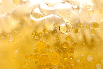 Abstract image of air bubbles and golden oil drip texture.