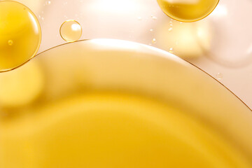 Golden yellow oil floats on the surface of the water.