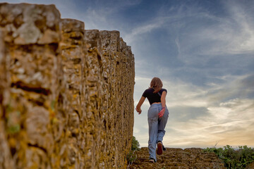 Naklejka premium A young woman in an ancient fortress