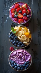 Three vibrant bowls of fruit and smoothie on a dark textured background, perfect for a healthy lifestyle theme. 