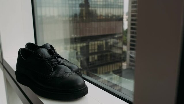 men's shoes black close-up on the window